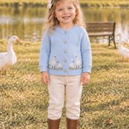 24-month-old toddler wearing the goose cardigan in the same farm scene