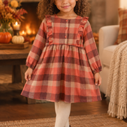 4-to-5-year-old biracial girl wearing the rust plaid dress