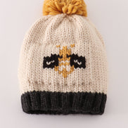 Beige pompom bee cable beanie