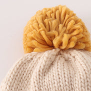 Beige pompom bee cable beanie