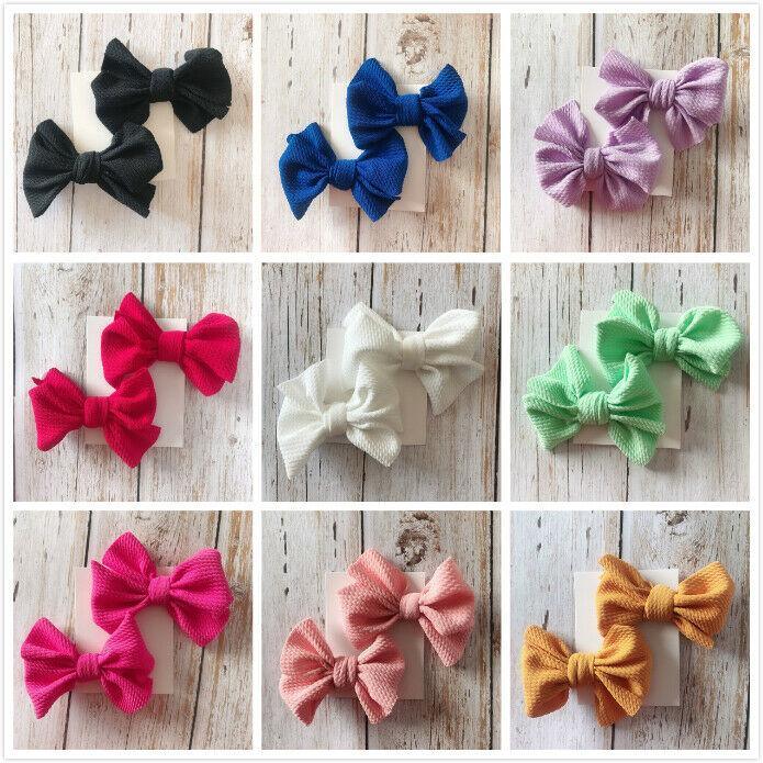 Collection of colorful hair bows on a wooden background