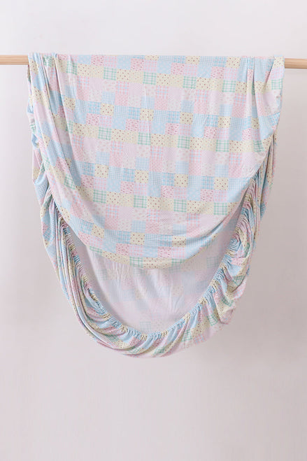 Pink floral checkered bamboo crib sheet