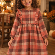 Biracial girl wearing the rust plaid dress