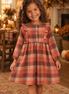 Biracial girl wearing the rust plaid dress
